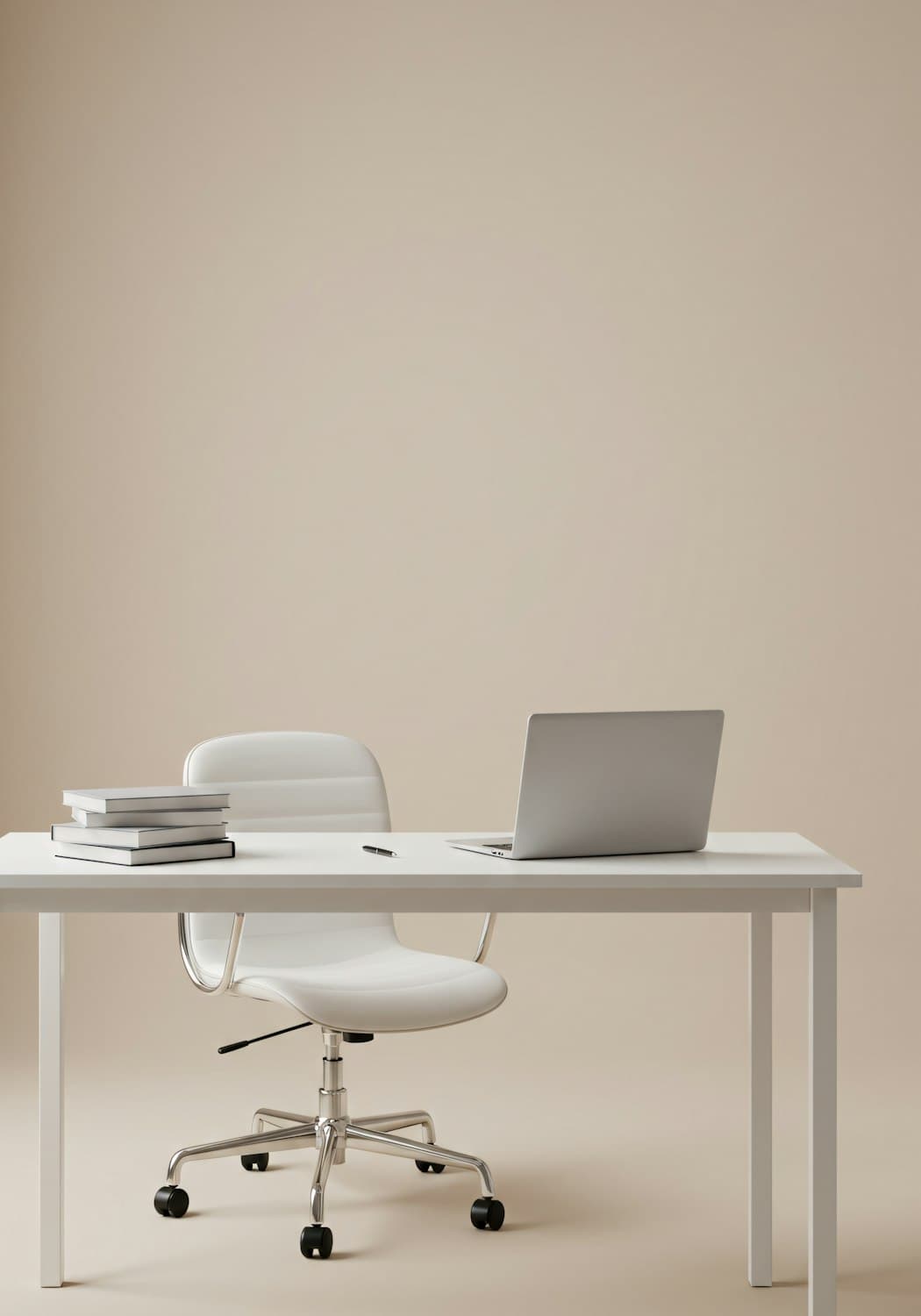 A tidy desk with a laptop, books and an adjustable office chair